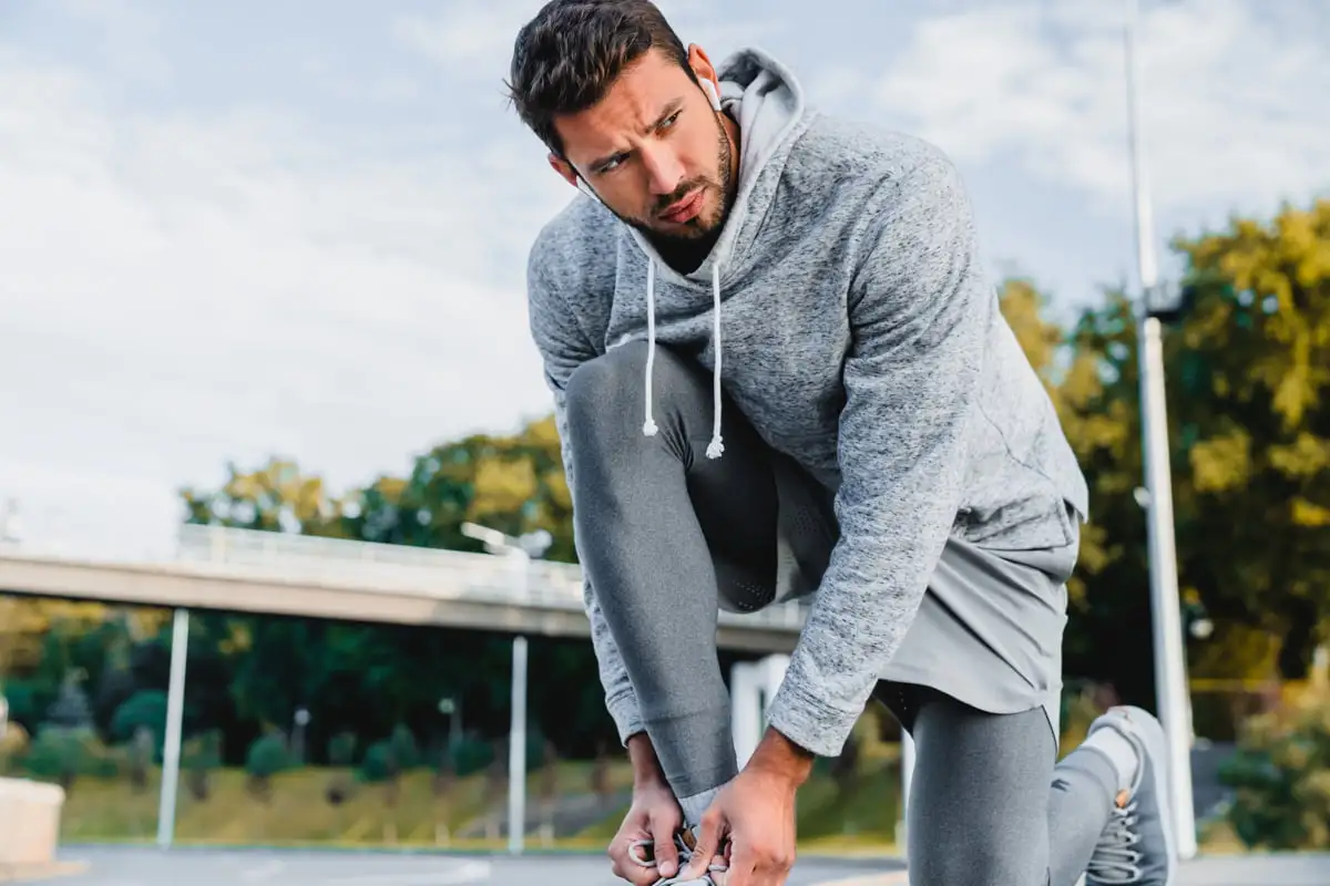 sportsman tying his shoelaces